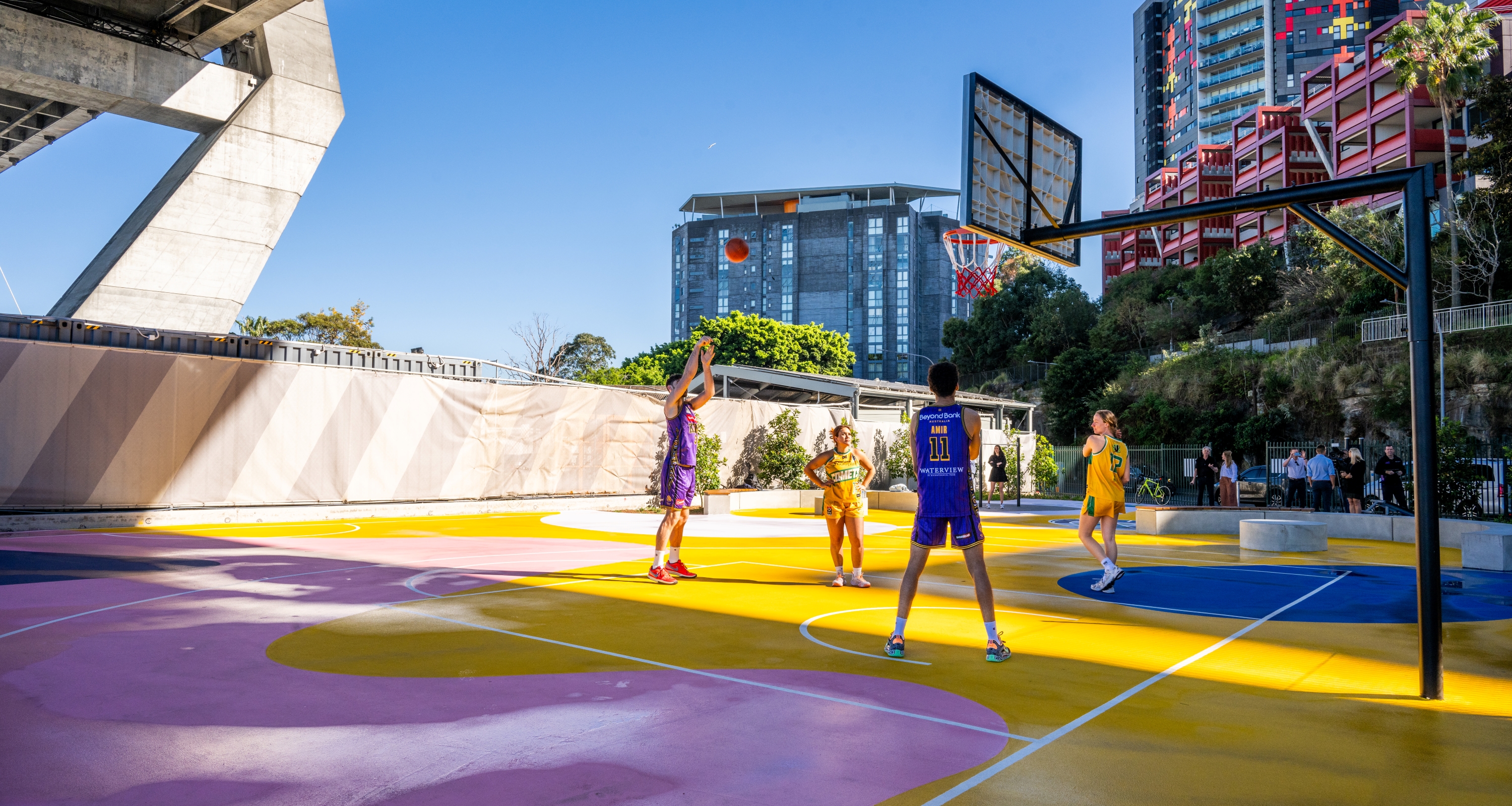 Basketball players shooting hoops at Bank Street Park basketball half court